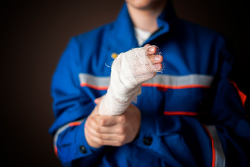 injured worker in uniform isolated on dark background b