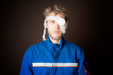 injured worker in uniform isolated on dark background b