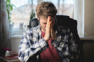 young man sit in chair and read morning pray b