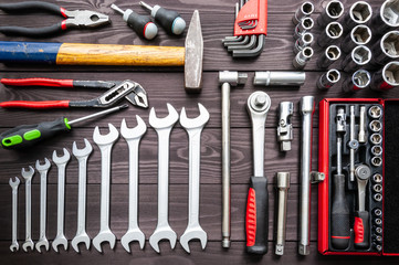 set of auto tools on dark wooden workbench.
