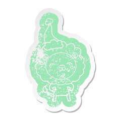 cartoon distressed sticker of a lion wearing santa hat
