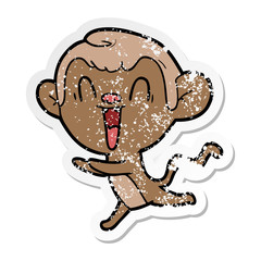 distressed sticker of a cartoon laughing monkey