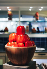 Fresh red organic paprika on wooden bowl. closeup