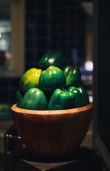 Fresh green organic paprika on wooden bowl. closeup