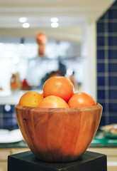 Fresh oranges in a wooden bowl. close-up