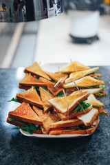 Triangular toast sandwiches with lettuce and ham on a plate