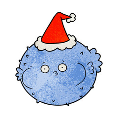 textured cartoon of a puffer fish wearing santa hat © lineartestpilot