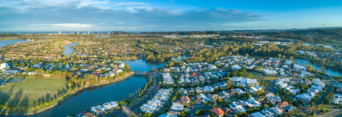 Aerial panorama of luxury suburb on the Gold Coast at sunset.