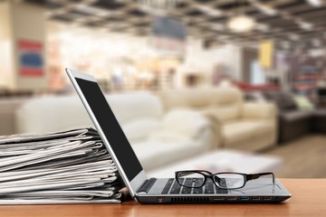 Laptop and black glasses  on   background.