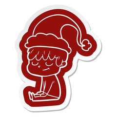 cartoon  sticker of a happy boy wearing santa hat