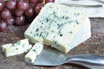 Blue Auvergne semi-hard AOP French blue cheese made from raw cow milk in Auvergne, France served as dessert with grapes