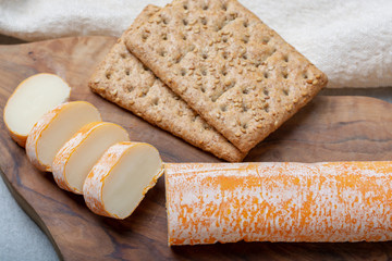 Fagotin cheese with  orange coloured rind made from cow milk in caves of Maredsous abbey, Belgium