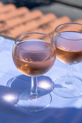 Rose wine of Provence, France, served cold on outdoor terrace in two wine glasses