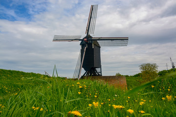 Old dark wooden wind mill in Heusden, North Brabant, Netherlands