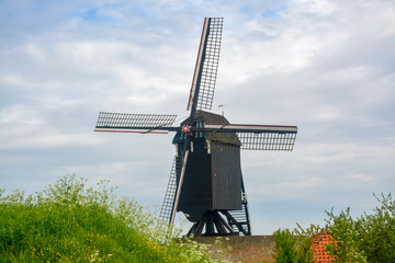 Old dark wooden wind mill in Heusden, North Brabant, Netherlands