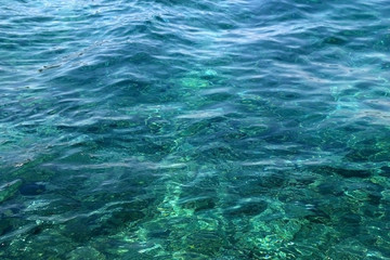 Sunlight reflects on a sea surface. Beautiful clear water. Selective focus.