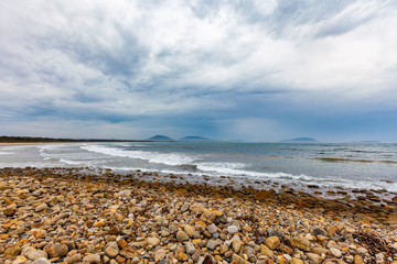 Fototapeta na wymiar Ocean coastline and pebbles on the beach at Crowdy Head, New South Wales, Australia