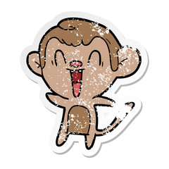 distressed sticker of a cartoon laughing monkey