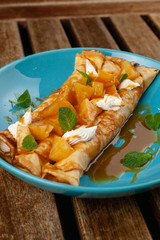 Sweet blini with pineapple and sauce