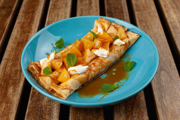 Sweet blini with pineapple and sauce