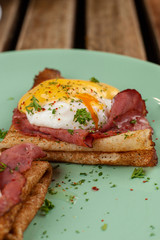 Pancakes with poached egg, ham and cheese sauce