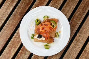 Shrovetide Maslenitsa festival. Russian pancakes blini with avocado, cheese, salmon and caviar