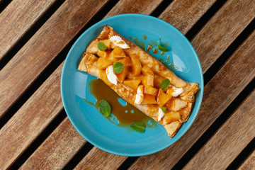 Sweet blini with pineapple and sauce