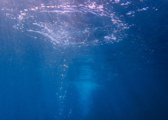 Scuba diving bubbles with sunrays coming down through them.