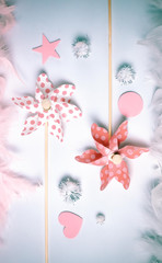 Toy windmills with pink and white feather border