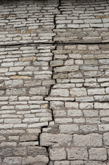 Stone wall texture. The crack in the fortress wall. Uneven rough stonework. Perfect for background and design.