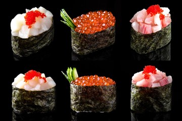 Gunkan set of salmon caviar, scallop, and sea bass on black background. Traditional Japanese cuisine