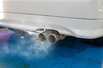 Car smog and air pollution from the exhaust pipe.