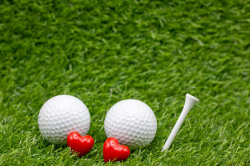 To golfer with love with two balls and tow hearts