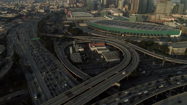 Above the highway in heavy traffic, sunset, cinematic aerial shot