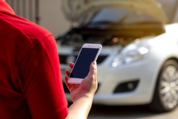 Agent man is calling the car service center because car is broken. The concept of customer service to home.