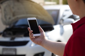 Agent man is calling the car service center because car is broken. The concept of customer service to home.