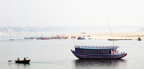 Beautiful boat in middle of winter river Ganges, boats for transporting people across river and...