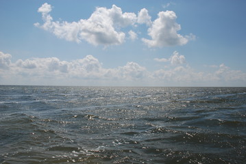 dark sparkling sea under the blue day sky