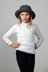 a little girl pretends to be a model