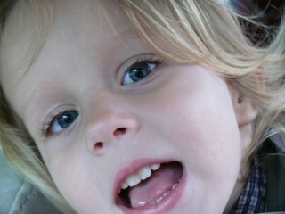 baby's face close with mouth open