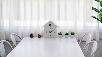 Obraz premium Modern dining room with table, chair and clock.