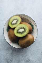 Green kiwi fruit on concrete background