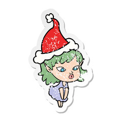 pretty distressed sticker cartoon of a elf girl wearing santa hat
