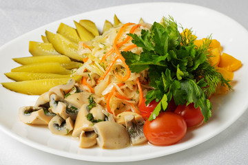 fish and mushroom and vegetable cuts for beer, pickled cucumbers,boiled eggs and lemon with micro greens