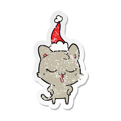 happy distressed sticker cartoon of a cat wearing santa hat