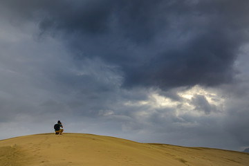 Photographer cum explorer at the top of desert mountain