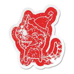 cartoon distressed sticker of a hungry wolf wearing santa hat