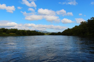 Beautiful Bystraya Malkinskaya river flows in valley between hills on the Kamchatka Peninsula, Russia.