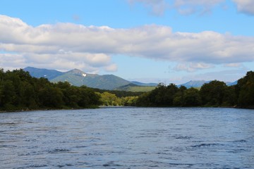 Beautiful Bystraya Malkinskaya river flows in valley between hills on the Kamchatka Peninsula, Russia.