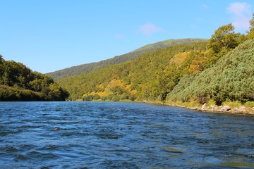 Beautiful Bystraya Malkinskaya river flows in valley between hills on the Kamchatka Peninsula, Russia.